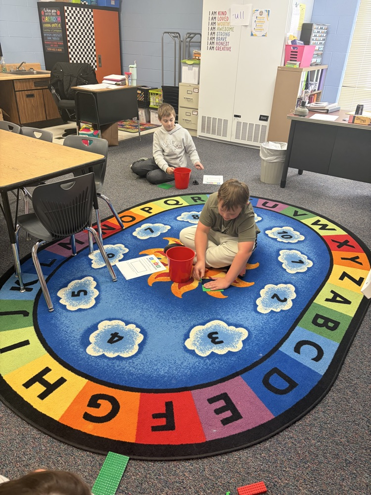 Fourth-grade students complete a mystery LEGO STEAM challenge, building unique creations and competing in a student-voted display.