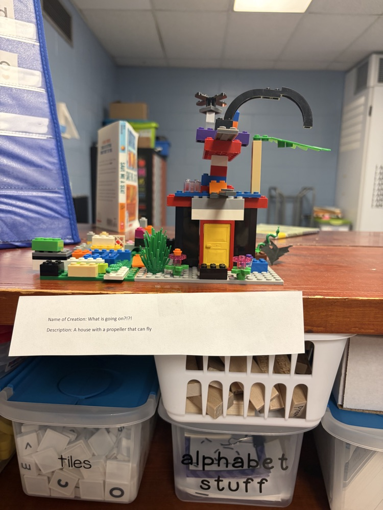 Fourth-grade students complete a mystery LEGO STEAM challenge, building unique creations and competing in a student-voted display.