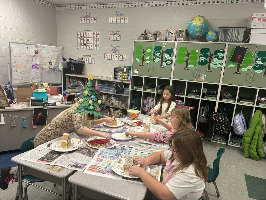 students decorate gingerbread houses