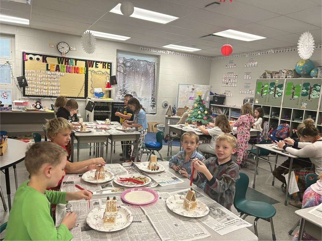 students decorate gingerbread houses