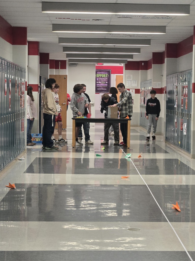 students building paper airplanes
