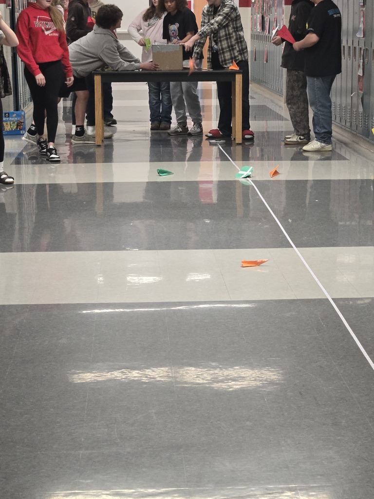 students building paper airplanes