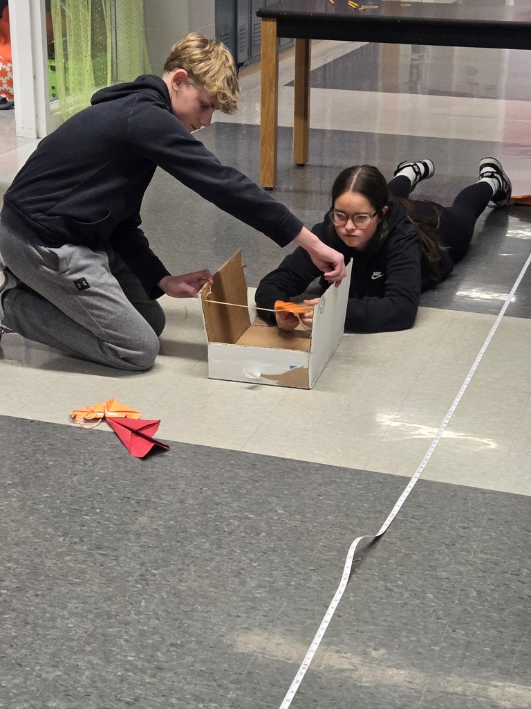 students building paper airplanes