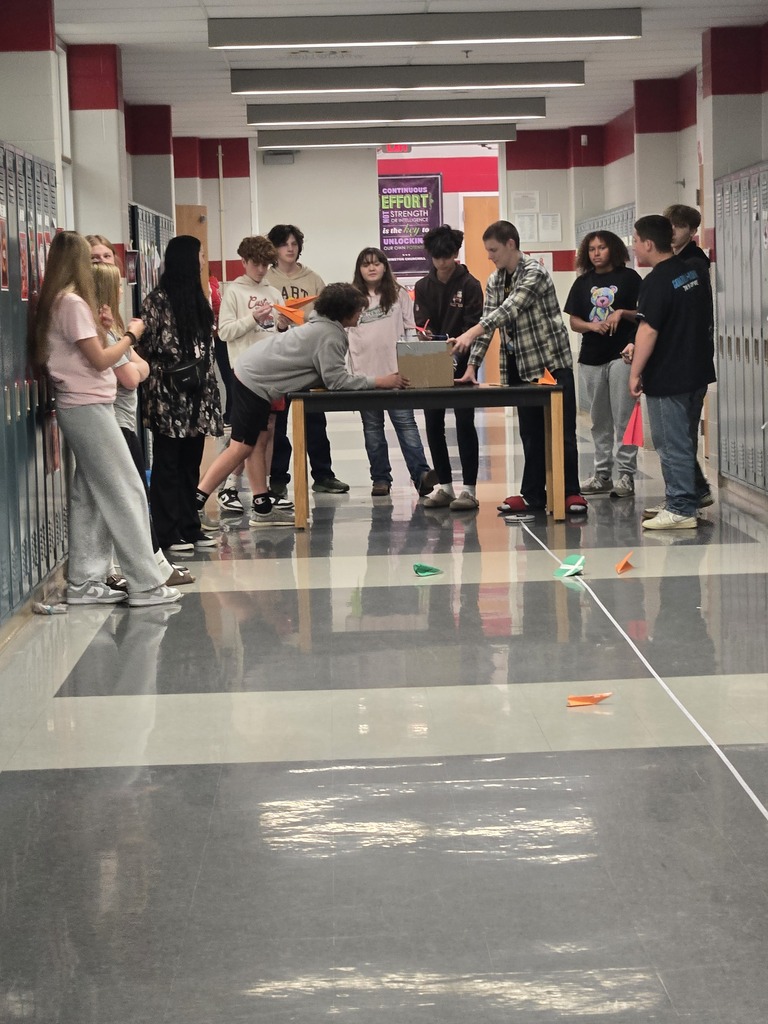 students building paper airplanes