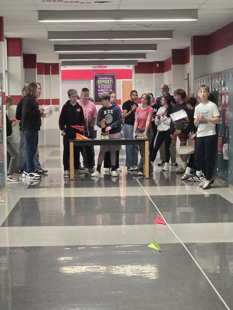 students building paper airplanes