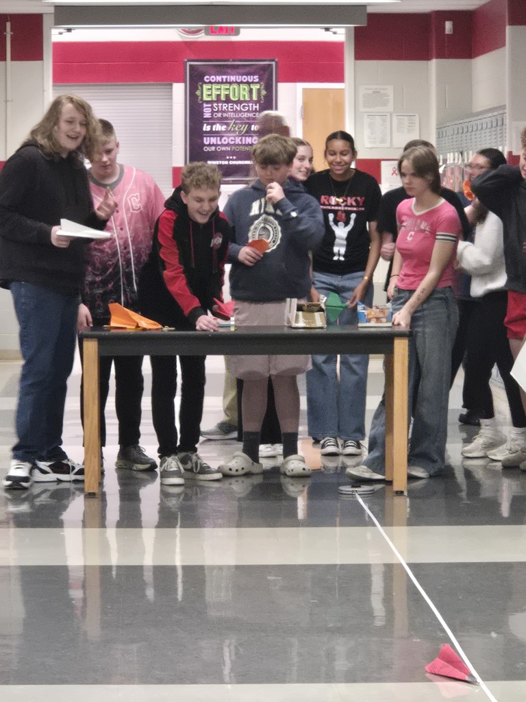 students building paper airplanes