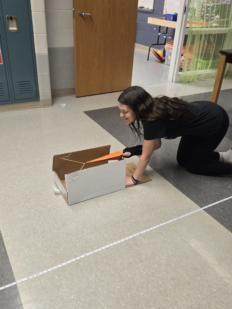 students building paper airplanes