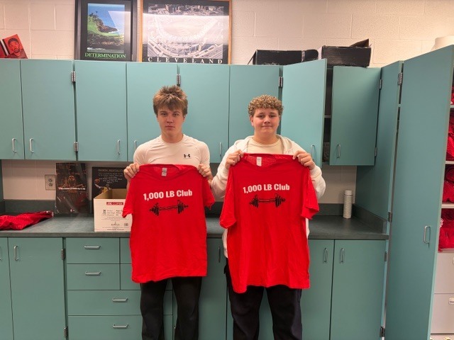 student holding shirt