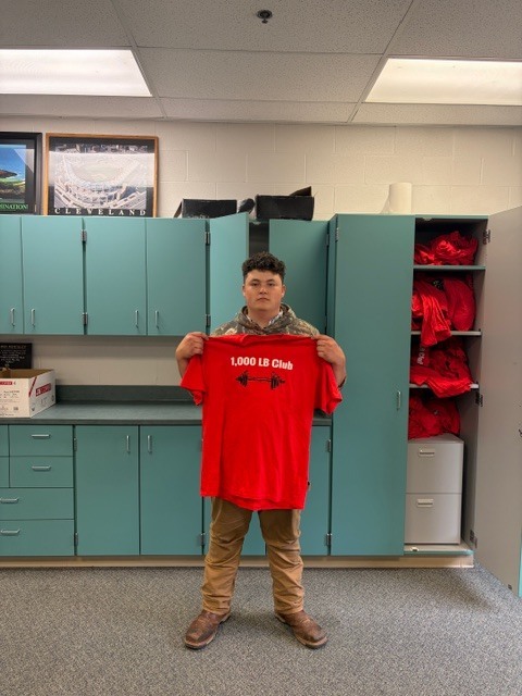 student holding shirt