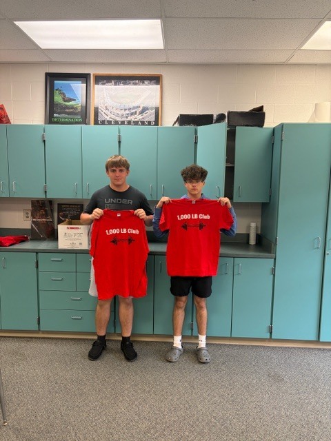 student holding shirt