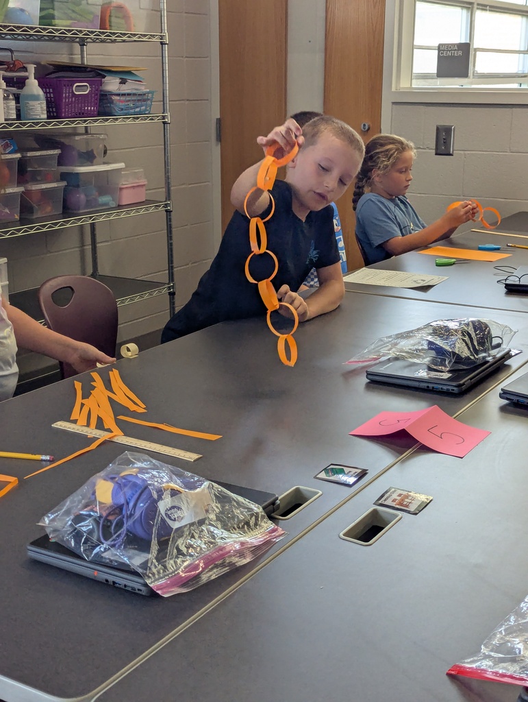 students making paper chain in computer class