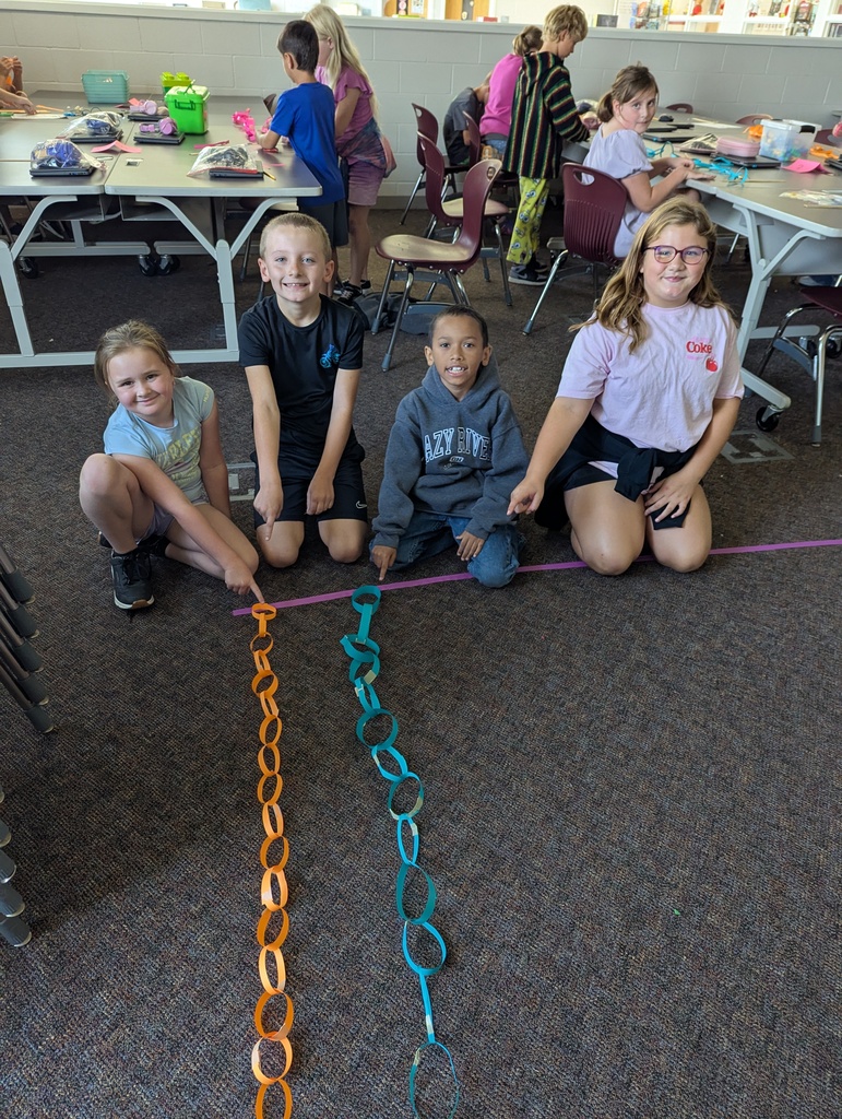 students making paper chain in computer class