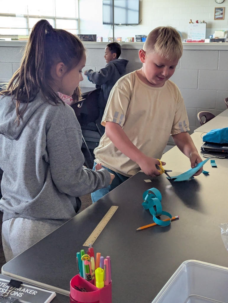 students making paper chain in computer class