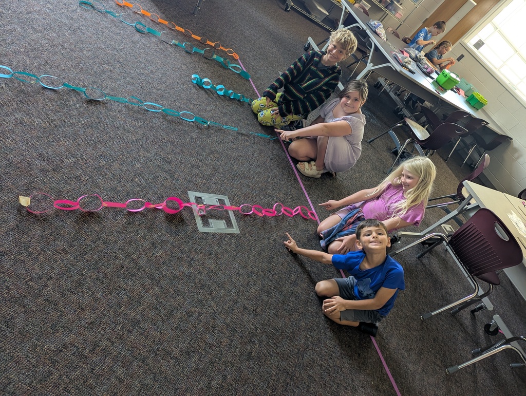 students making paper chain in computer class