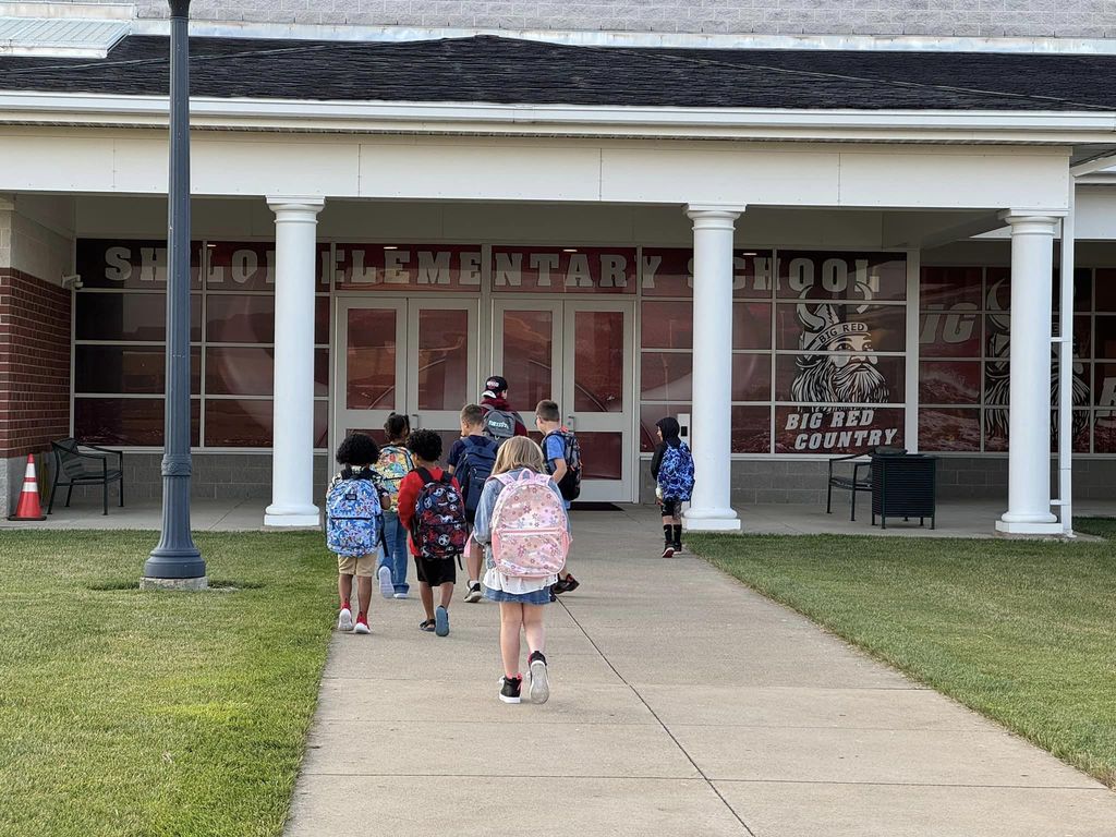 students walking into school