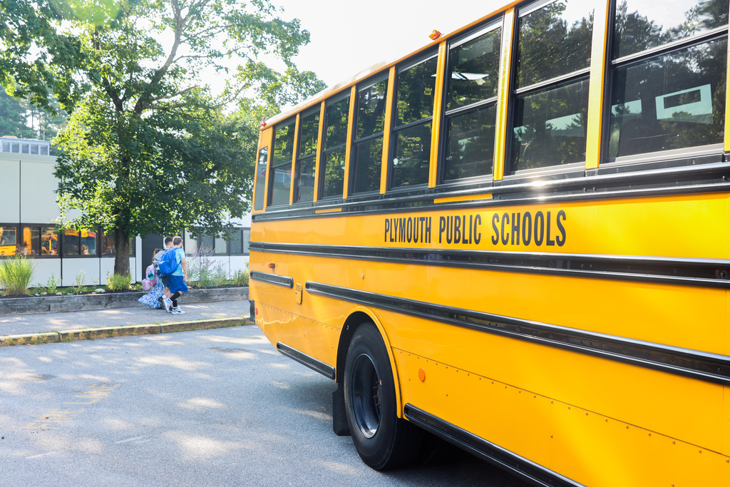 Yellow school bus with Plymouth Public Schools written on the side.