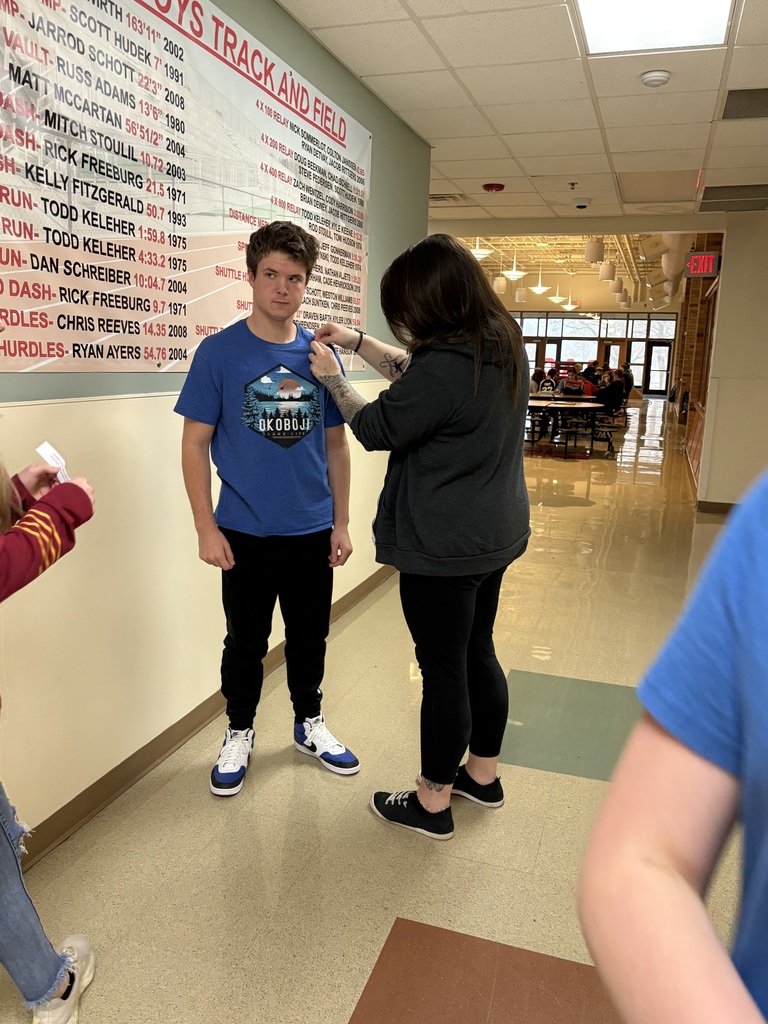 Student getting a butterfly pin