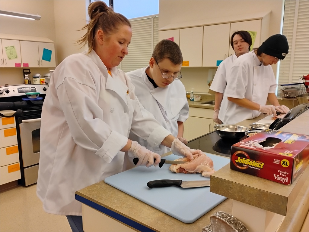 student and teacher fabricate a chicken