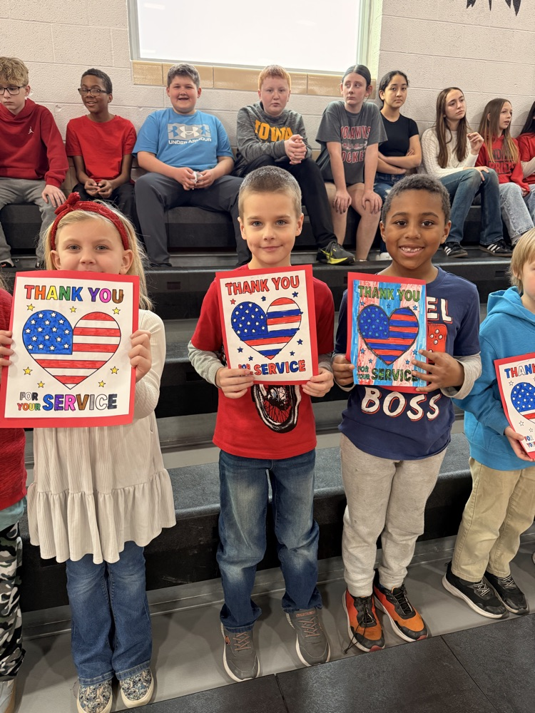First grade holds posters thanking Miss Ford for her service