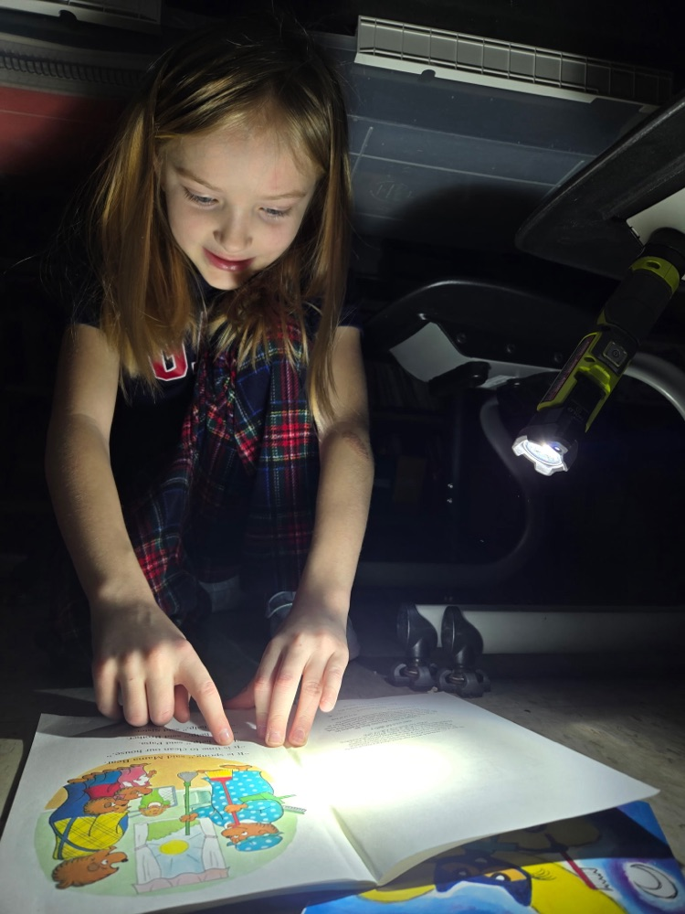 first grade reading with flashlights