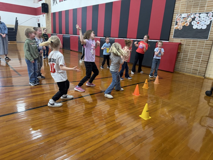 students are dancing in the gym