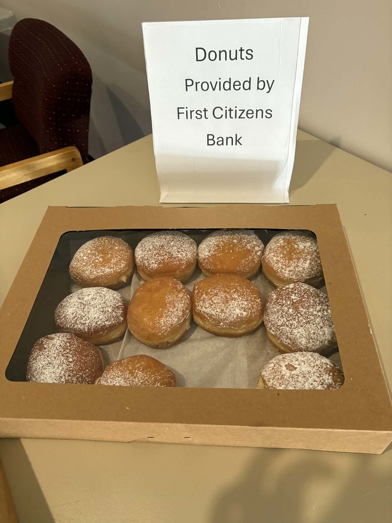 donuts with a sign that says "Donuts provided by First Citizens Bank"
