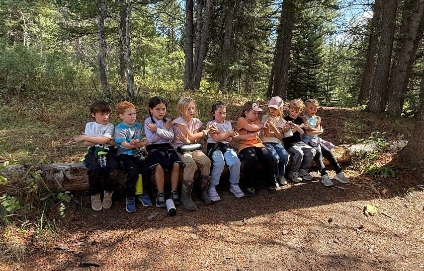 Griggs Crew Students sitting on a log