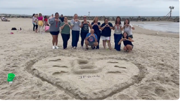 Staff and Heart Carved into Sand