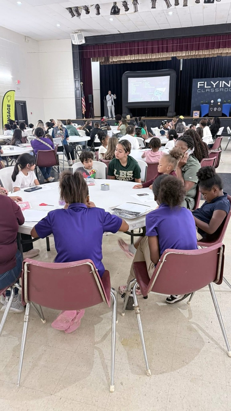 students were at a table with their families
