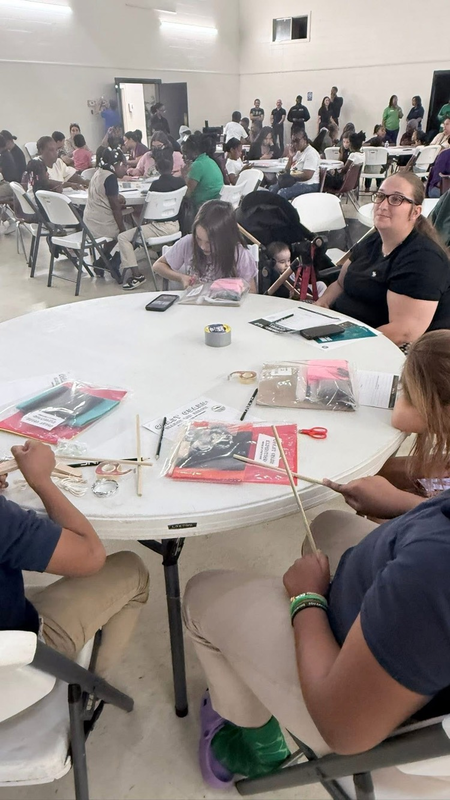 students working with their family