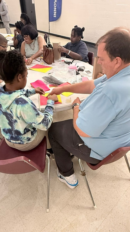 Family working on their craft at the event