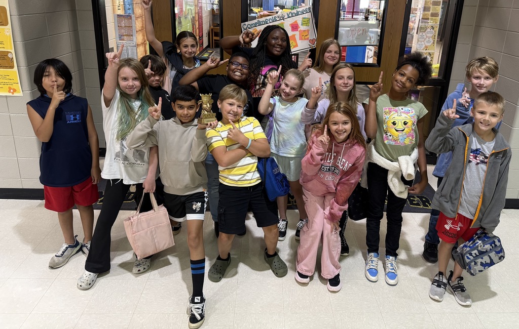 Mrs. ONeal's class holding up 1st place fingers while posing with the GOAT trophy. 