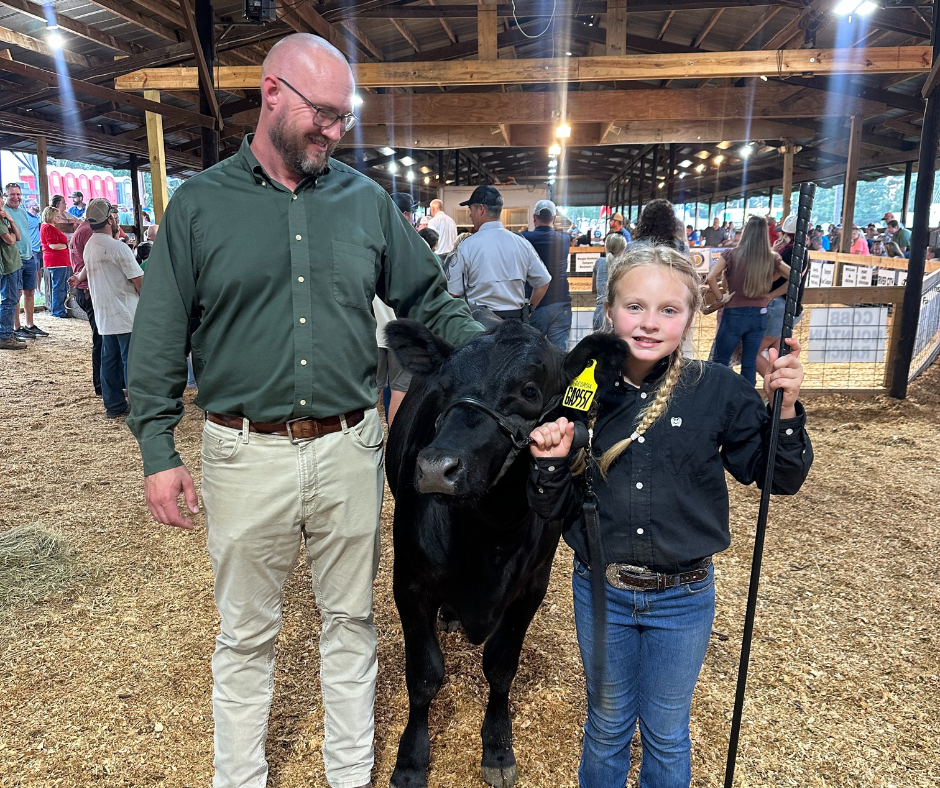 Eastside principal with Olivia Hettlinger at cow show