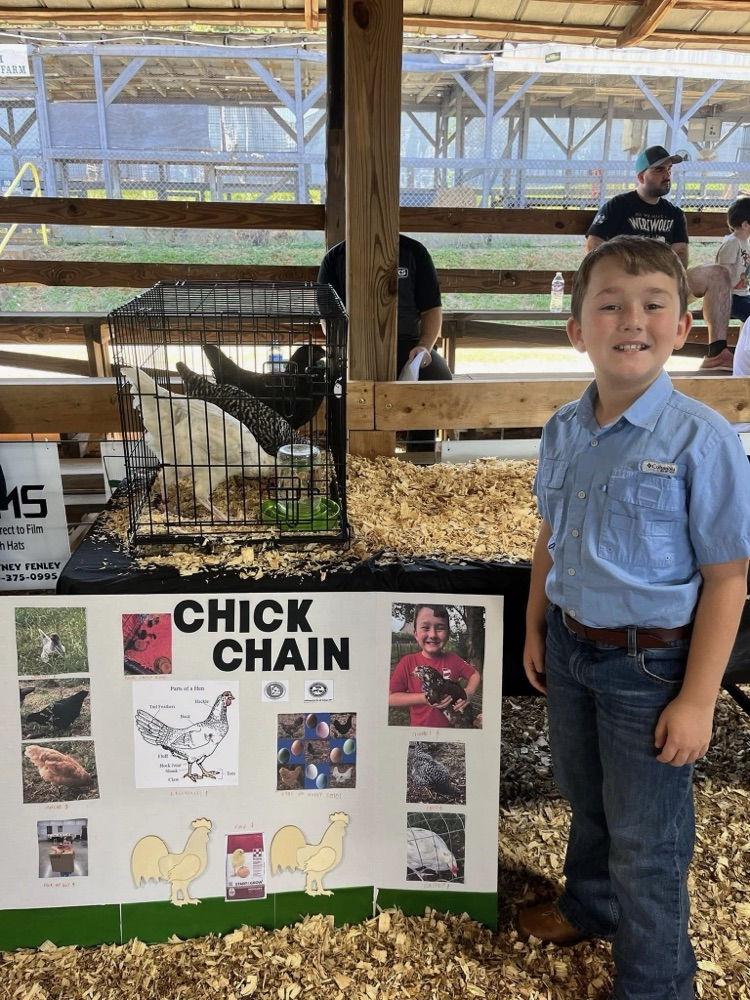 pic of Grayson at the fair with his project 