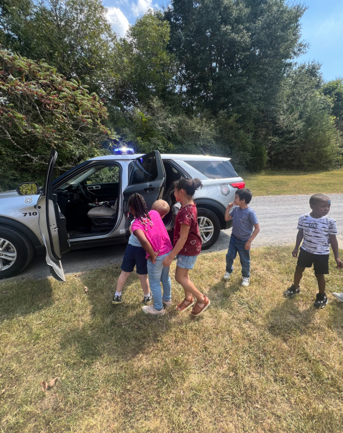 Ms. Williams’ students exploring Officer Ray’s vehicle while learning about community helpers!