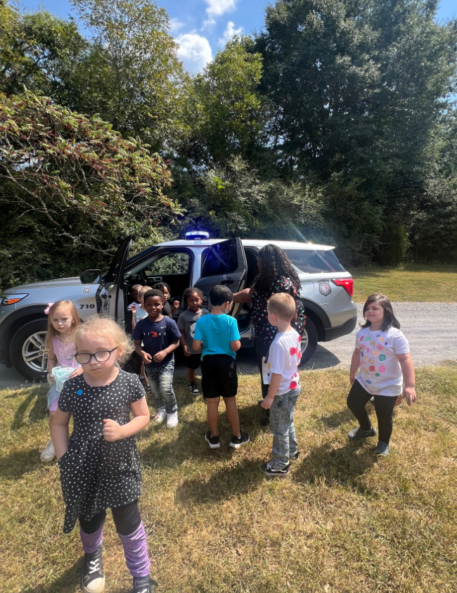Ms. Williams’ students exploring Officer Ray’s vehicle while learning about community helpers!
