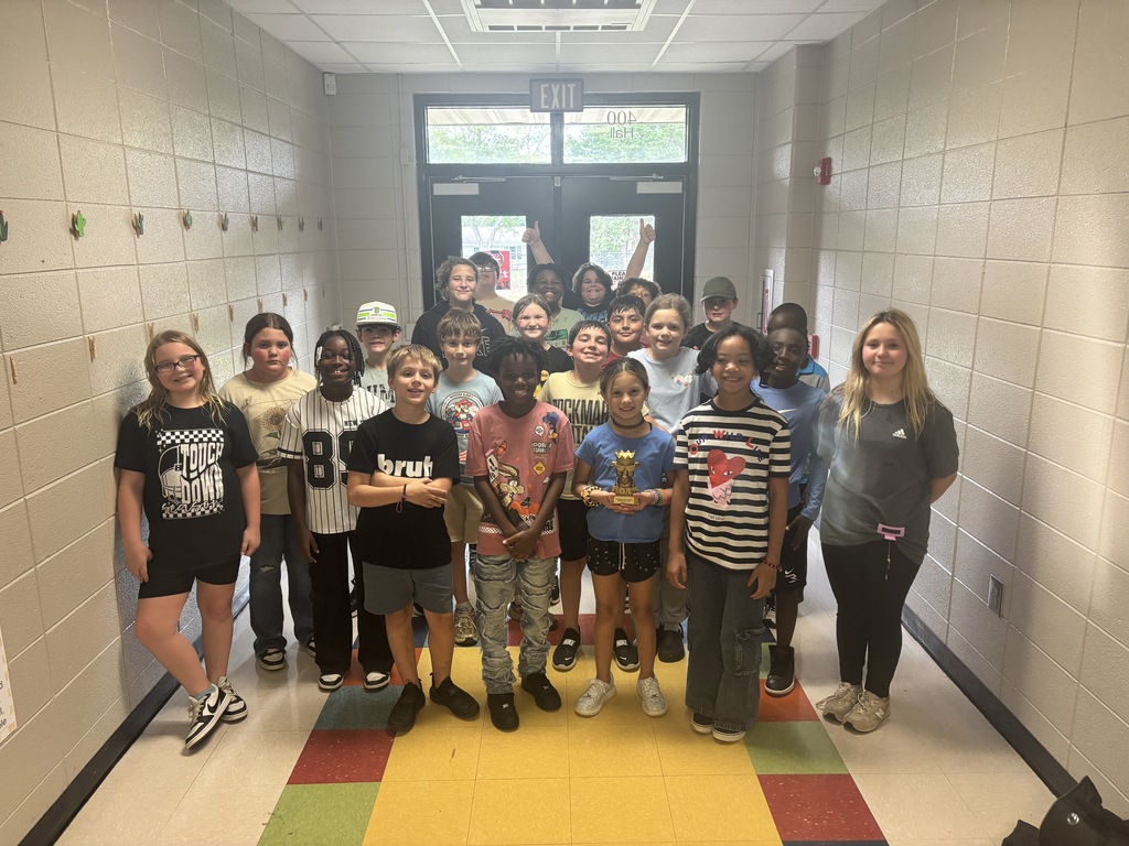 Students posing with the GOAT trophy. 