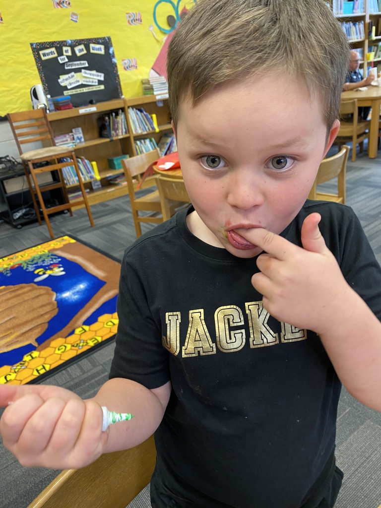 Grayson enjoying his gel icing very much. He's licking his fingers. 
