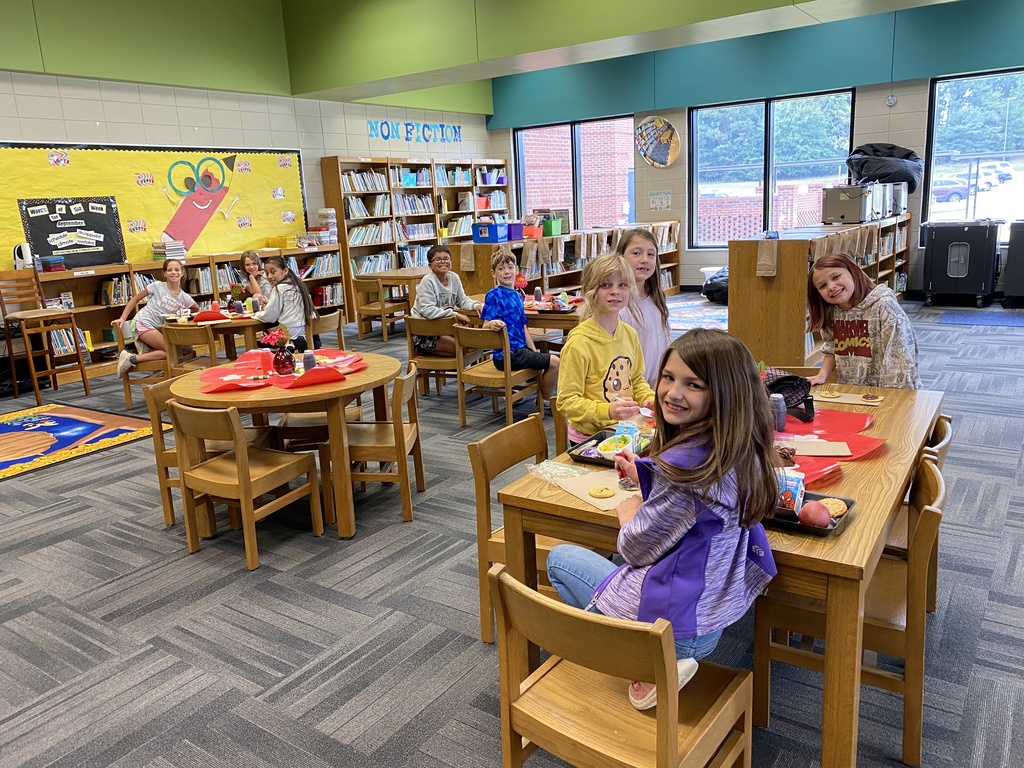 4th grader winners of the AR challenge smiling for the camera while decorating their cookies