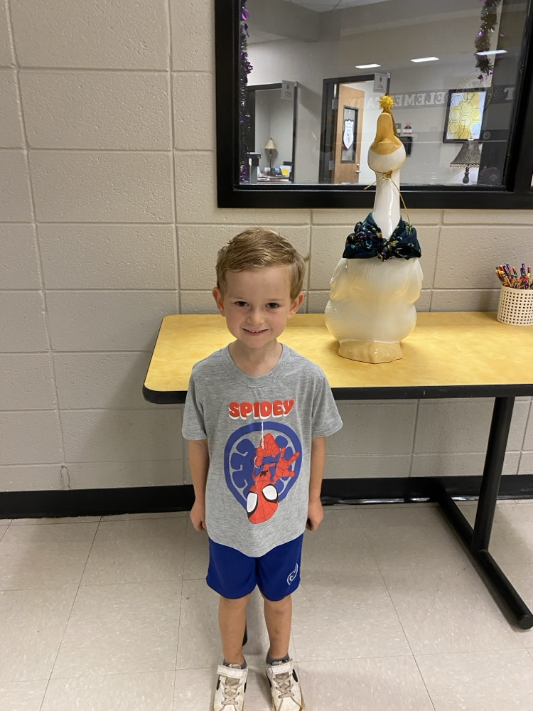  a student posing with the goose for his birthday pic