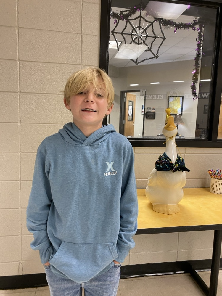  a student posing with the goose for his birthday pic