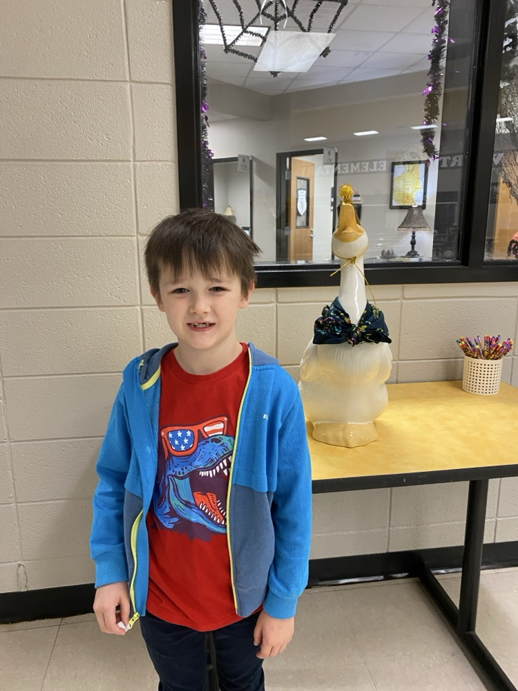  a student posing with the goose for his birthday pic