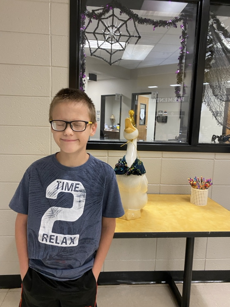  a student posing with the goose for his birthday pic