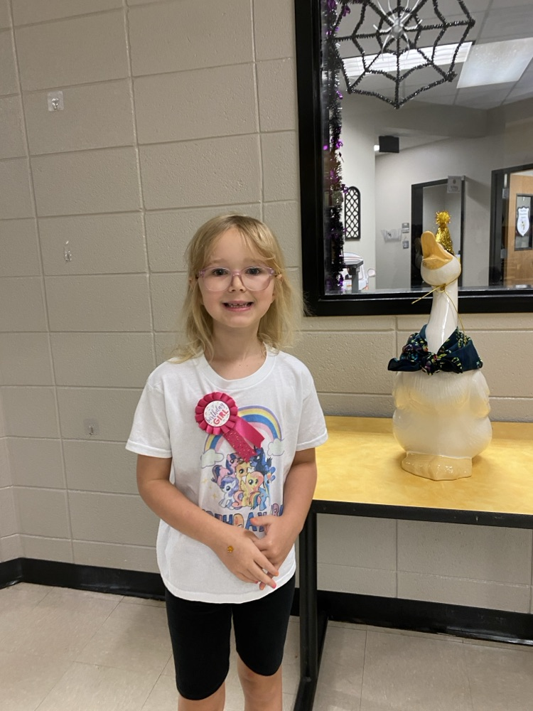  a student posing with the goose for his birthday pic