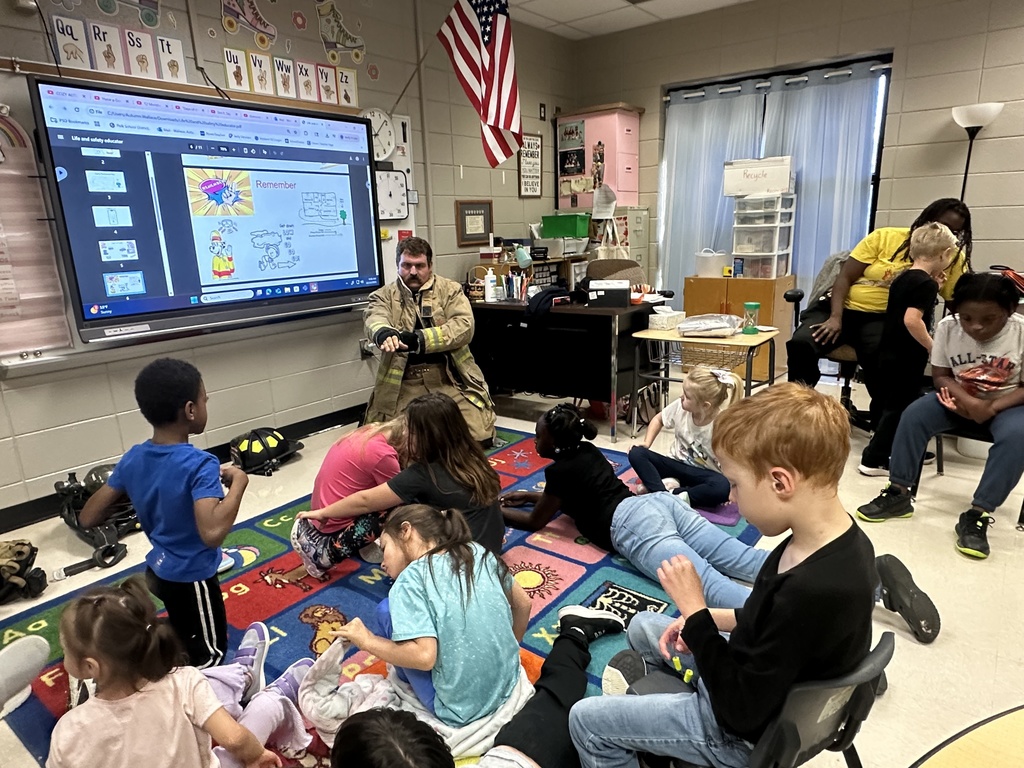 Mr. Hall's class listening to the firefighter read.