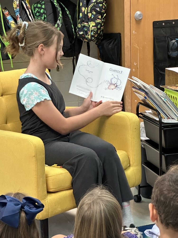 Anna reading to a class.