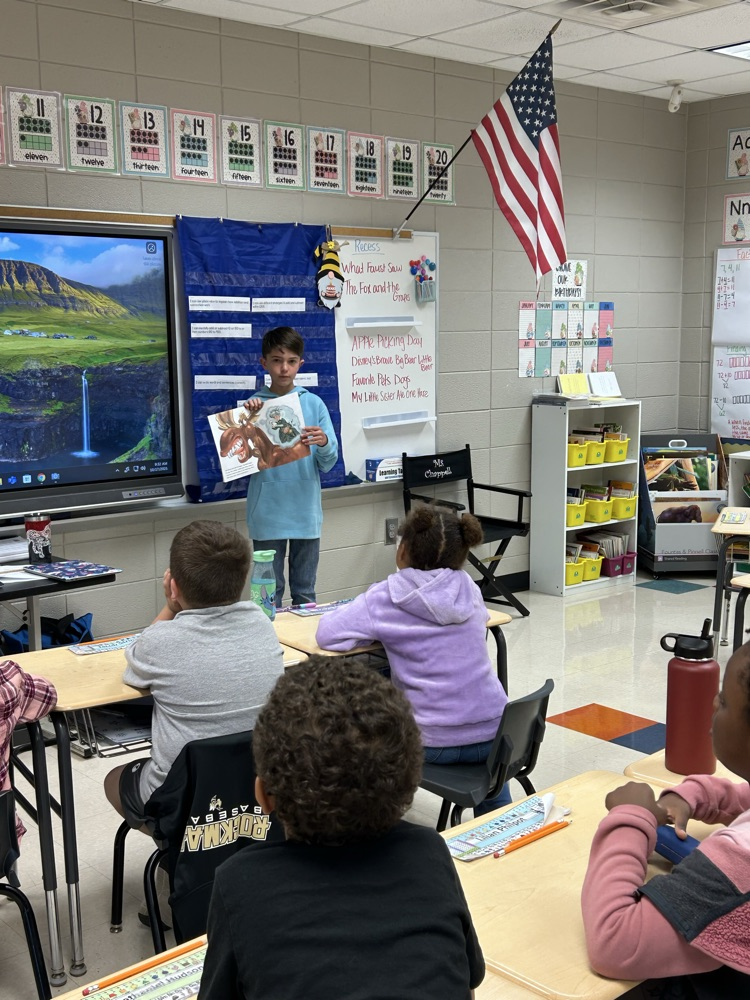 a student reading to a class.