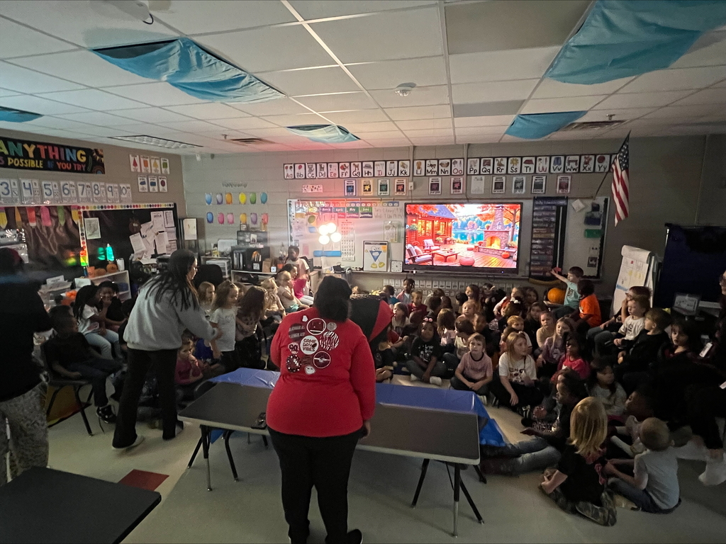Pumpkin science with kindergarteners - Picture of a pumpkin exploding yellow ooze out it's mouth. Students watching it.