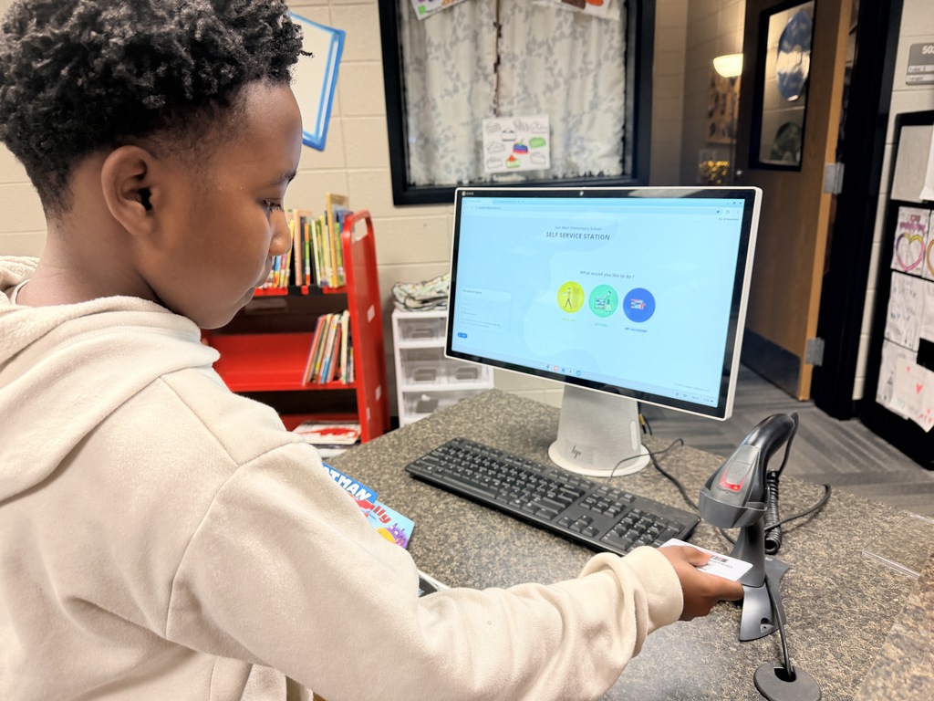 Grayson checking out is books. 