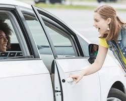 Woman opening car door in car rider line